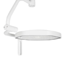White ceiling-mounted dental operatory light with curved arm and circular lamp head